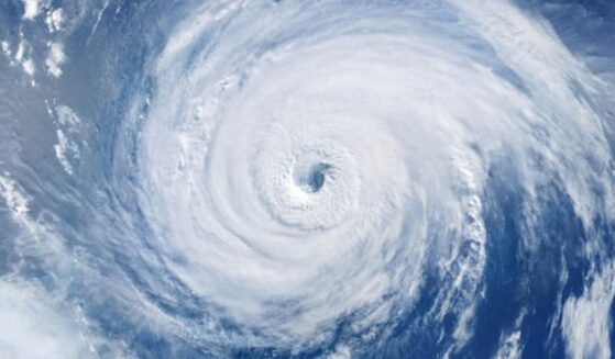 A hurricane is pictured as winds and clouds circle around the eye of the storm.