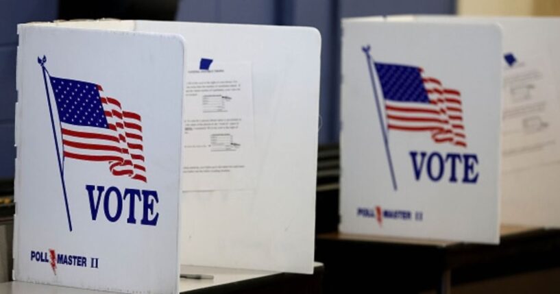 The voting booths stand on a table.