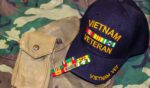 A Vietnam veteran’s hat is pictured on a camouflage fabric.