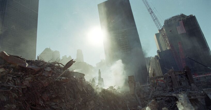 Smoke rises from the debris at 