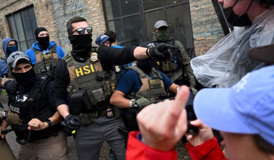 Agents from Immigration and Custom's Enforcement (ICE) clash with angry agitators in Chicago on June 4, 2025.