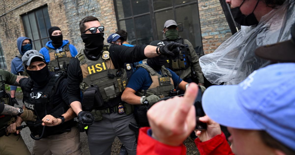 Agents from Immigration and Custom's Enforcement (ICE) clash with angry agitators in Chicago on June 4, 2025.