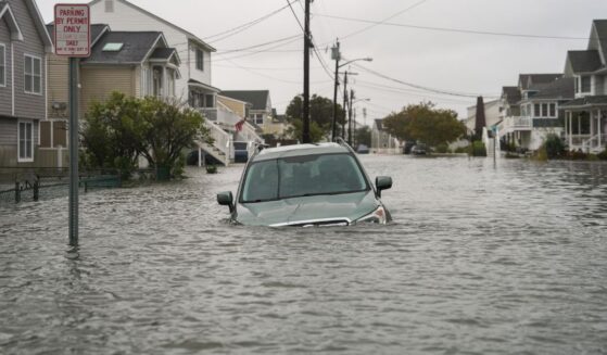 A car is seen submerged in water on a flooded road in Point Pleasant, New Jersey, on Sept. 26, 2026.