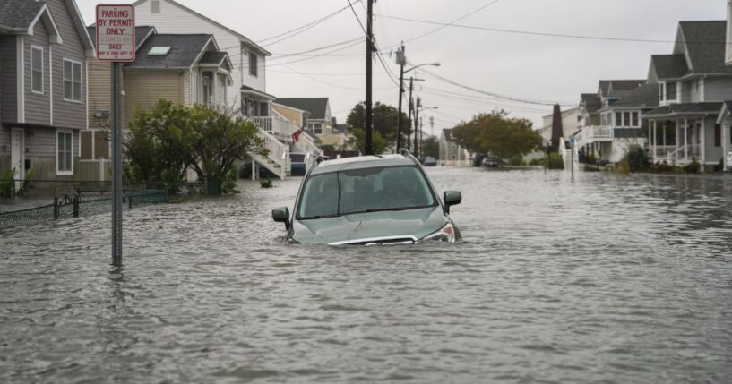 A car is seen submerged in water on a flooded road in Point Pleasant, New Jersey, on Sept. 26, 2026.