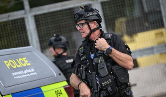 An armed police man mans a roadblock at the entrance to the RAF Fairford air base in England during a counter-terrorism investigation on Sept. 27, 2026.