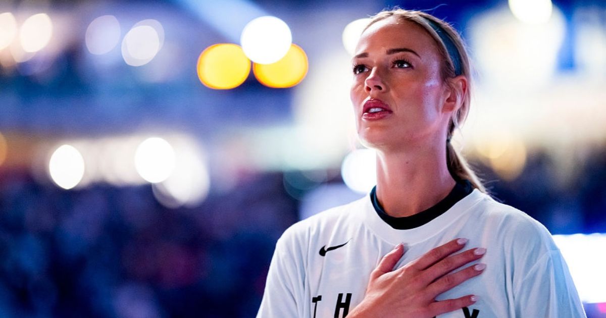 Sophie Cunningham #8 of the Indiana Fever salutes the flag Sept. 18 during the national anthem prior to play against the WNBA's Toronto Tempo in Toronto, Canada.