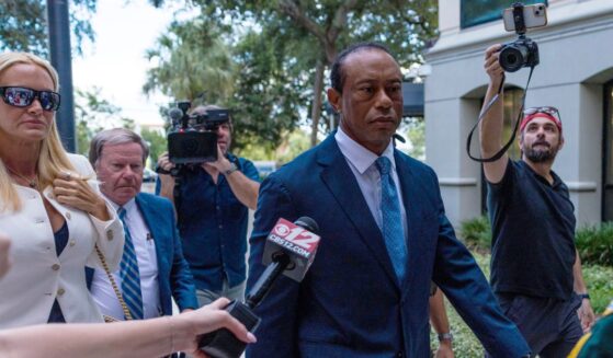 Tiger Woods, accompanied by Vanessa Trump, left, attends a hearing at Martin County Courthouse Wednesday in Stuart, Florida, in connection with a crash that occurred on Jupiter Island in March.