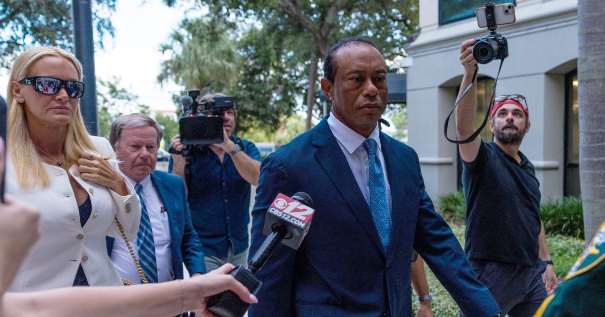 Tiger Woods, accompanied by Vanessa Trump, left, attends a hearing at Martin County Courthouse Wednesday in Stuart, Florida, in connection with a crash that occurred on Jupiter Island in March.