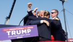 Then-candidate Donald Trump is surrounded by Secret Service agents after being wounded in a July 2024 assassination attempt in Butler, Pennsylvania.