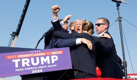 Then-candidate Donald Trump is surrounded by Secret Service agents after being wounded in a July 2024 assassination attempt in Butler, Pennsylvania.