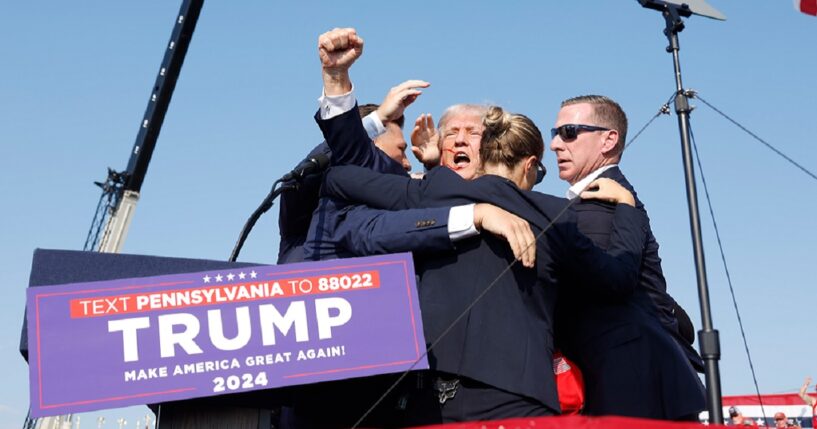 Then-candidate Donald Trump is surrounded by Secret Service agents after being wounded in a July 2024 assassination attempt in Butler, Pennsylvania.