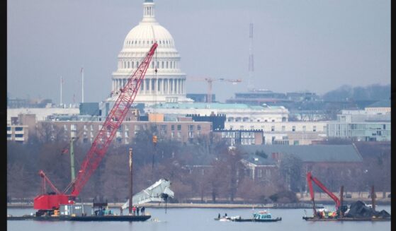 A crane lifts a piece of American Airlines flight 5342 from the Potomac River during recovery efforts on Feb. 3, 2025, in Arlington, Virginia. An American Airlines flight from Wichita, Kansas collided midair with a military Black Hawk helicopter while on approach to Ronald Reagan Washington National Airport outside of Washington, D.C., on Jan. 29, 2025 .