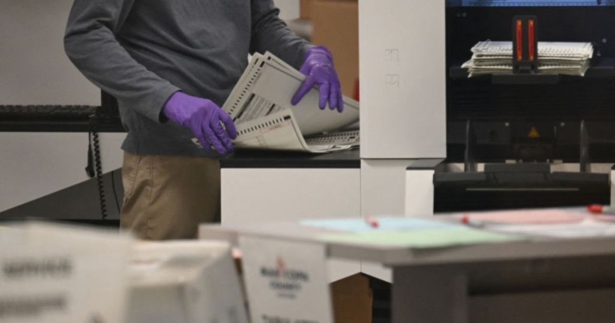An election worker counts ballots inside the Maricopa County Tabulation and Election Center in Phoenix, Arizona, in a file photo dated Nov. 6, 2024.