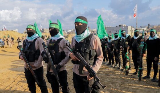 Palestinian Hamas fighters gather at the site of the handing over of the bodies of four Israeli hostages in Khan Yunis in the southern Gaza Strip on Feb. 20, 2025.