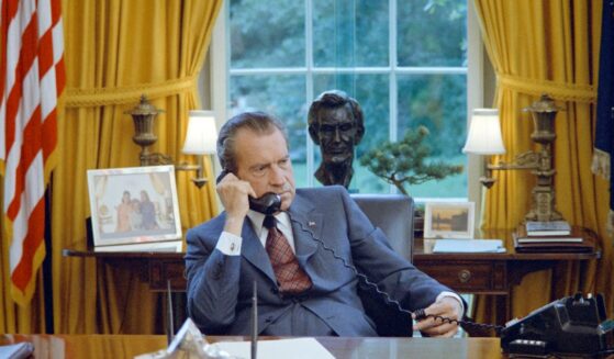 President Richard Nixon talks on the telephone at his desk in the White House's Oval Office, in Washington, D.C., on June 23, 1972.