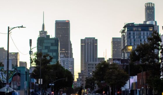 A homeless man walks on the street in Skid Row on July 25, 2025, in downtown Los Angeles, California.