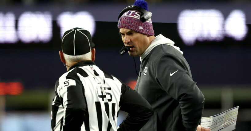 Head coach Mike Kafka of the New York Giants speaks with line judge Jeff Seeman during the fourth quarter of the game against the New England Patriots at Gillette Stadium on Dec. 1, 2025, in Foxborough, Massachusetts.