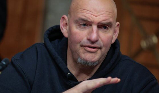 Sen. John Fetterman prepares to vote to advance Sen. Markwayne Mullin to be Secretary of the Department of Homeland Security during a markup hearing in the Dirksen Senate Office Building on Capitol Hill on March 19, 2026, in Washington, D.C.