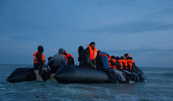 Migrants sit aboard a dinghy as they prepare to sail into the English Channel on Sept. 21, 2026, in Gravelines, France.