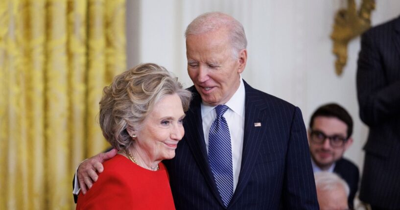 Former Secretary of State Hillary Clinton greets President Joe Biden before being awarded the Presidential Medal of Freedom in the East Room of the White House on Jan. 4, 2025, in Washington, D.C.