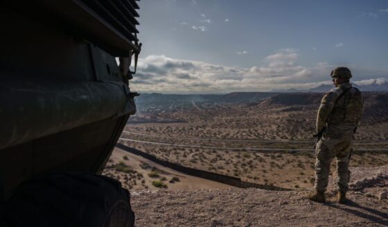 A U.S. Army soldier stands next to a Stryker armored infantry transport vehicle, which has been deployed along the Mexican border as part of the military's Joint Task Force Southern Border mission, in Sunland Park, New Mexico, on April 4, 2025.
