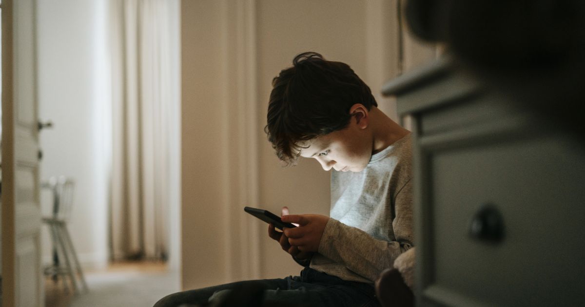 A boy playing video games at home.