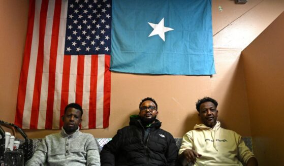 Patrons watch a soccer game as they sit under an American and Somali flag at a cafe inside 24 Somali Mall on Dec. 2, 2025, in Minneapolis, Minnesota.