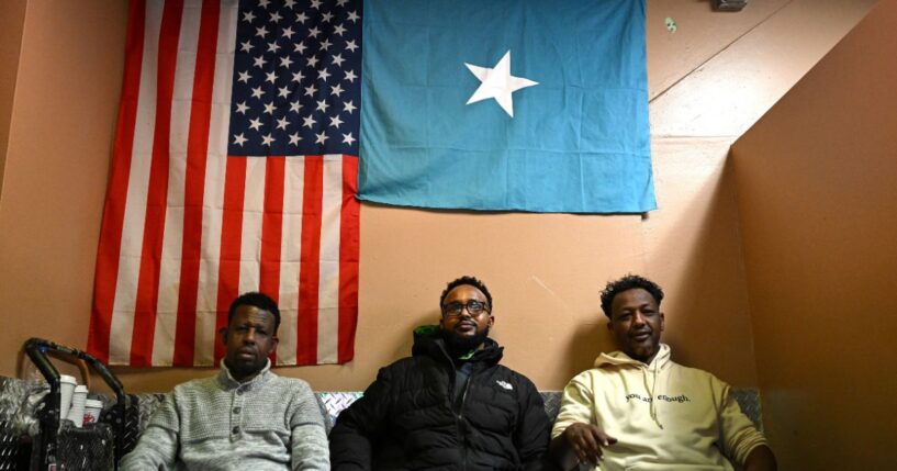 Patrons watch a soccer game as they sit under an American and Somali flag at a cafe inside 24 Somali Mall on Dec. 2, 2025, in Minneapolis, Minnesota.