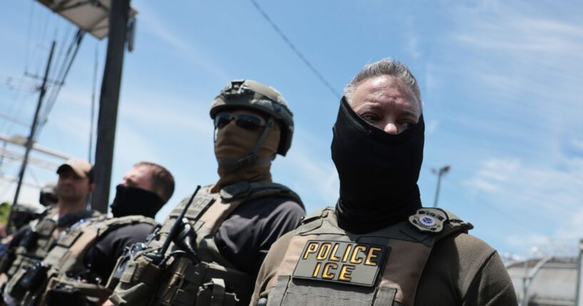 ICE agents stand guard in front of protesters outside Delaney Hall, which is being used as an Immigration and Customs Enforcement detention center, on May 26, 2026, in Newark, New Jersey.