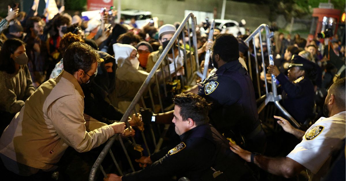 Protesters and law enforcement officers clash close to the scene where a man was shot by an Immigration and Customs Enforcement officer during an operation in the Bronx borough of New York on Oct. 8, 2026, according to local media and police.