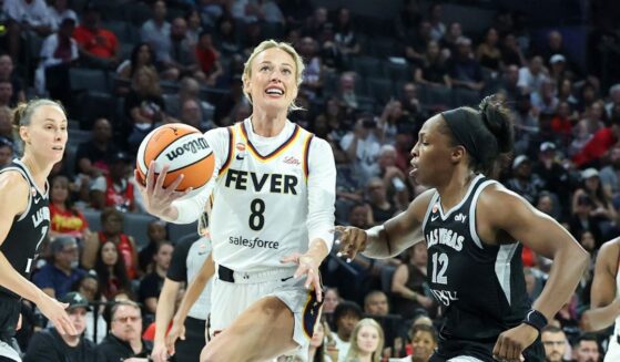 Sophie Cunningham of the Indiana Fever drives to the basket as she is fouled by Chelsea Gray of the Las Vegas Aces in the fourth quarter of Game One of the 2026 WNBA Playoffs first round at Michelob ULTRA Arena on Sept. 27, 2026, in Las Vegas, Nevada.