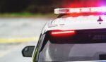 Police block a road at the scene of an emergency.