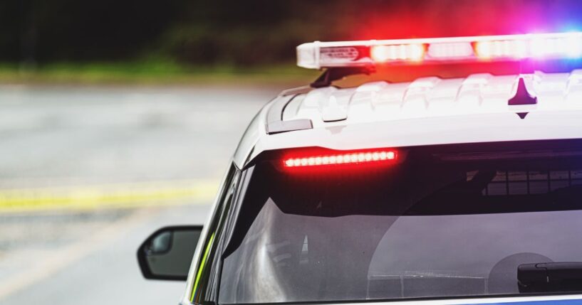 Police block a road at the scene of an emergency.