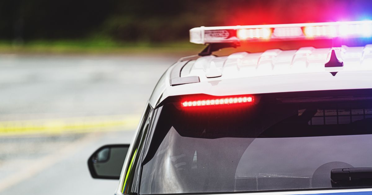 Police block a road at the scene of an emergency.