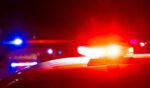 Red and blue police lights on a car at a crime scene at night with copy space.