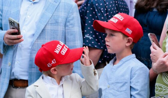 Guests donning Make America Great Again hats wait to greet President Donald Trump at the congressional picnic on the South Lawn of the White House on May 19, 2026, in Washington, D.C.
