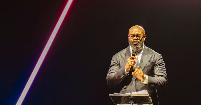 Pastor John Amanchukwu leads the daily prayer at Turning Point's AmericaFest conference, in remembrance of late right-wing political activist Charlie Kirk, in Phoenix, Arizona, on Dec. 18, 2025.