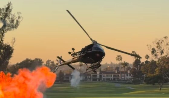 A helicopter drops small explosives at Newport Beach Country Club in California on Oct. 8, 2026.