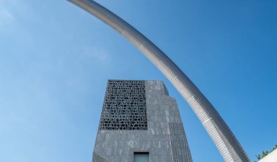 A stainless steel arch sculpture, Bending the Arc by artist Martin Puryear, frames the main tower of the Obama Presidential Center in Chicago's historic Jackson Park.