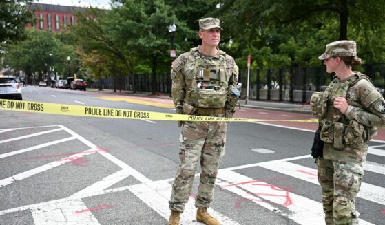 U.S. National Guard members stand by a police line after a car crashed into a barricade near the White House in Washington, D.C., on Sept. 19, 2026.