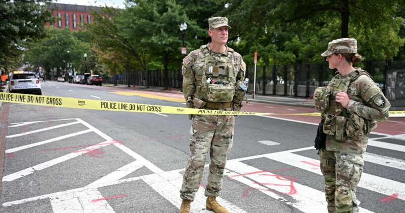 U.S. National Guard members stand by a police line after a car crashed into a barricade near the White House in Washington, D.C., on Sept. 19, 2026.