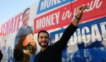 Abdul El-Sayed waves to supporters near his campaign bus after a rally in Flint, Michigan, on Oct. 18, 2026.