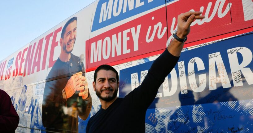 Abdul El-Sayed waves to supporters near his campaign bus after a rally in Flint, Michigan, on Oct. 18, 2026.