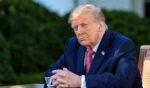 President Donald Trump listens as First Lady Melania Trump delivers remarks as he prepares to sign an executive order in the Rose Garden of the White House on Oct. 19, 2026, in Washington, D.C.