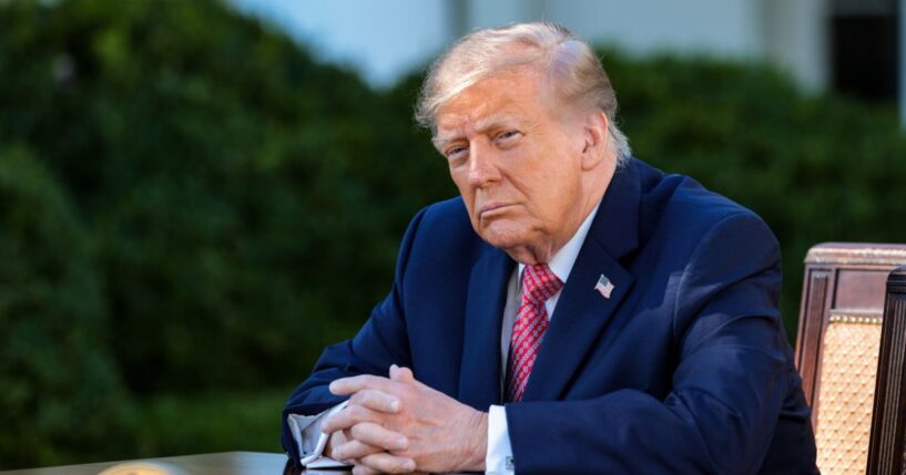 President Donald Trump listens as First Lady Melania Trump delivers remarks as he prepares to sign an executive order in the Rose Garden of the White House on Oct. 19, 2026, in Washington, D.C.