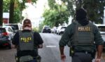 Federal agents walk near the scene where a man was shot by an Immigration and Customs Enforcement officer during an operation in the Bronx borough of New York on Oct. 8, 2026, according to local media and police.