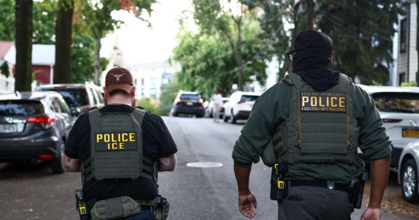 Federal agents walk near the scene where a man was shot by an Immigration and Customs Enforcement officer during an operation in the Bronx borough of New York on Oct. 8, 2026, according to local media and police.