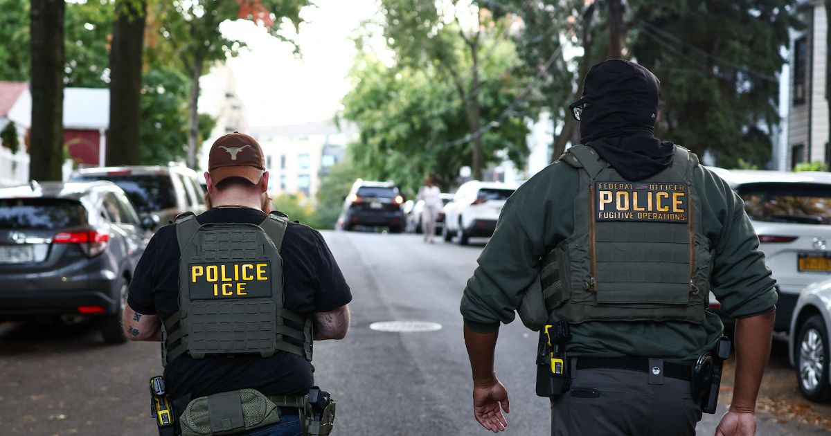 Federal agents walk near the scene where a man was shot by an Immigration and Customs Enforcement officer during an operation in the Bronx borough of New York on Oct. 8, 2026, according to local media and police.