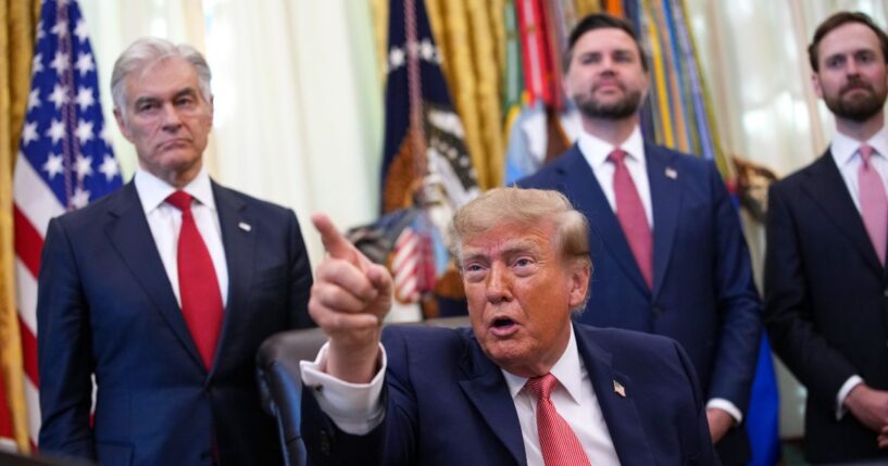 President Donald Trump gestures to reporters during an event in the Oval Office of the White House on Oct. 20, 2026, in Washington, D.C.