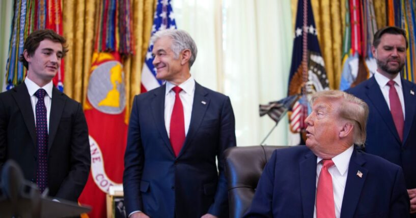 President Donald Trump acknowledges conservative influencer Nick Shirley as Administrator for the Centers for Medicare & Medicaid Services Dr. Mehmet Oz and Vice President J.D. Vance look on during an event in the Oval Office of the White House on Oct. 20, 2026, in Washington, D.C.